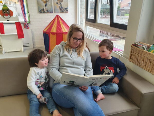 Stephanie leest voor aan twee kinderen